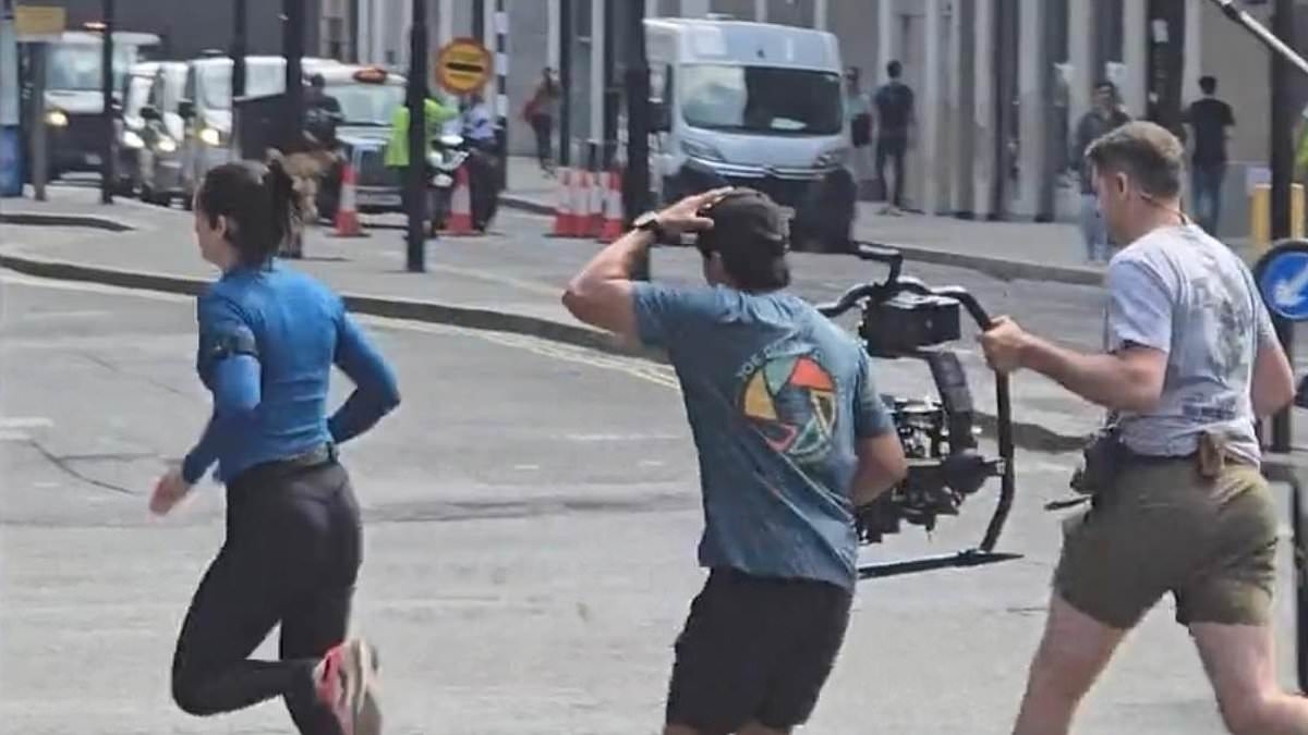 Gal Gadot sprints across a road while filming in East London for latest movie