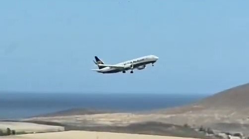 Terrifying moment Ryanair passenger jet lurches from side to side and is forced to abort its landing moments after touching down during storm in Tenerife