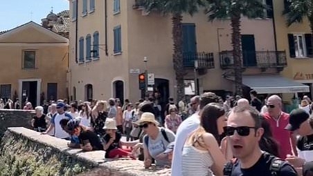 Fury in Italy as 75,000 tourists jam streets of quaint Lake Garda village as video shows arguing holidaymakers trying to barge their way in to fairytale castle