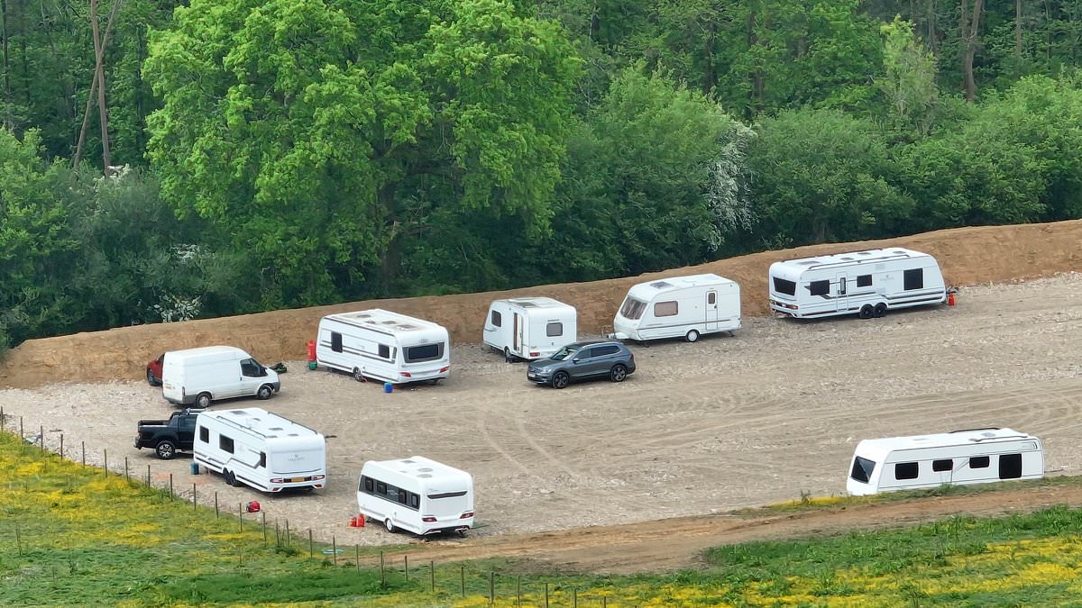 Travellers in fleet of caravans take over huge field in the South Downs National Park after the land was illegally torn up by diggers over Bank Holiday weekend