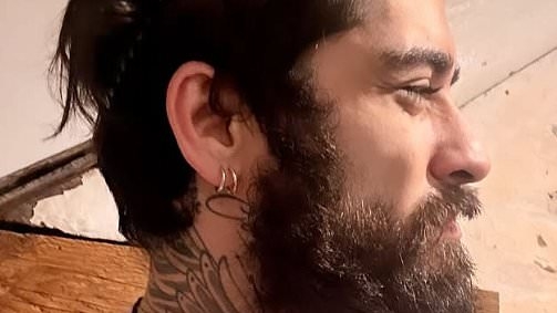 Zayn Malik sports thick beard as he reveals VERY rugged appearance in an unreleased football shirt after friends shares fears for his wellbeing after 1D