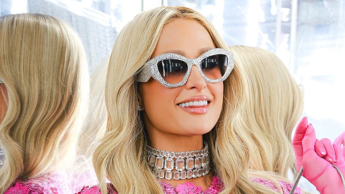 Paris Hilton stuns in a pink floral mini dress as she's supported by sister Nicky and pal Martha Stewart at her Parívie launch party in NYC