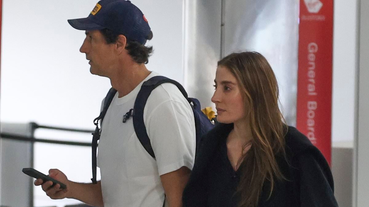 Close call! Former celebrity couple Megan Gale and Andy Lee narrowly avoid each other at Sydney Airport as the comedian jets off with fiancée Rebecca Harding