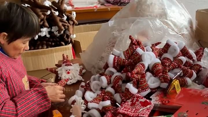 Inside eerie 'Chinese Lapland' where army of workers produce 80% of the world's Christmas decorations with mountain of stock piled floor to ceiling in 'never-ending nightmare' grotto