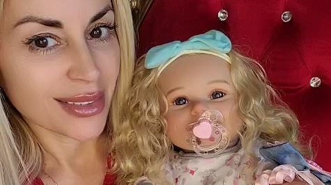 'Human Barbie' spends £350 on lifelike baby doll so she doesn't get empty nest syndrome (and she even dresses and feeds the toy)