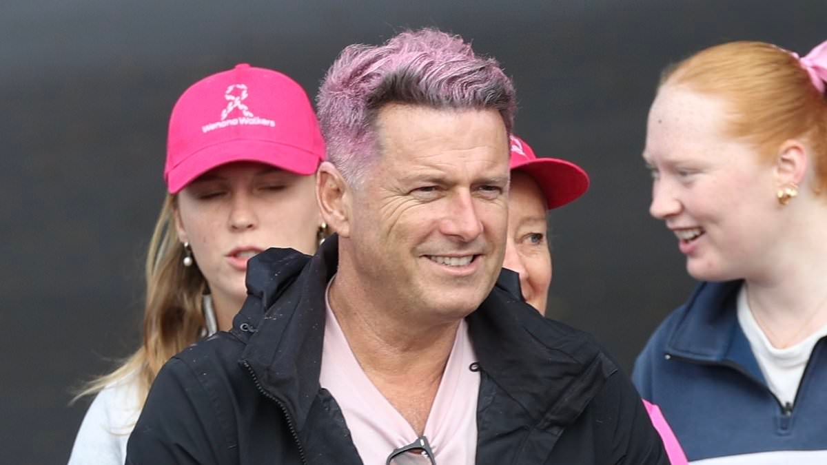 Today show host Karl Stefanovic shows off his new pink hair as he participates in the Mother's Day Classic walk with his wife Jasmine
