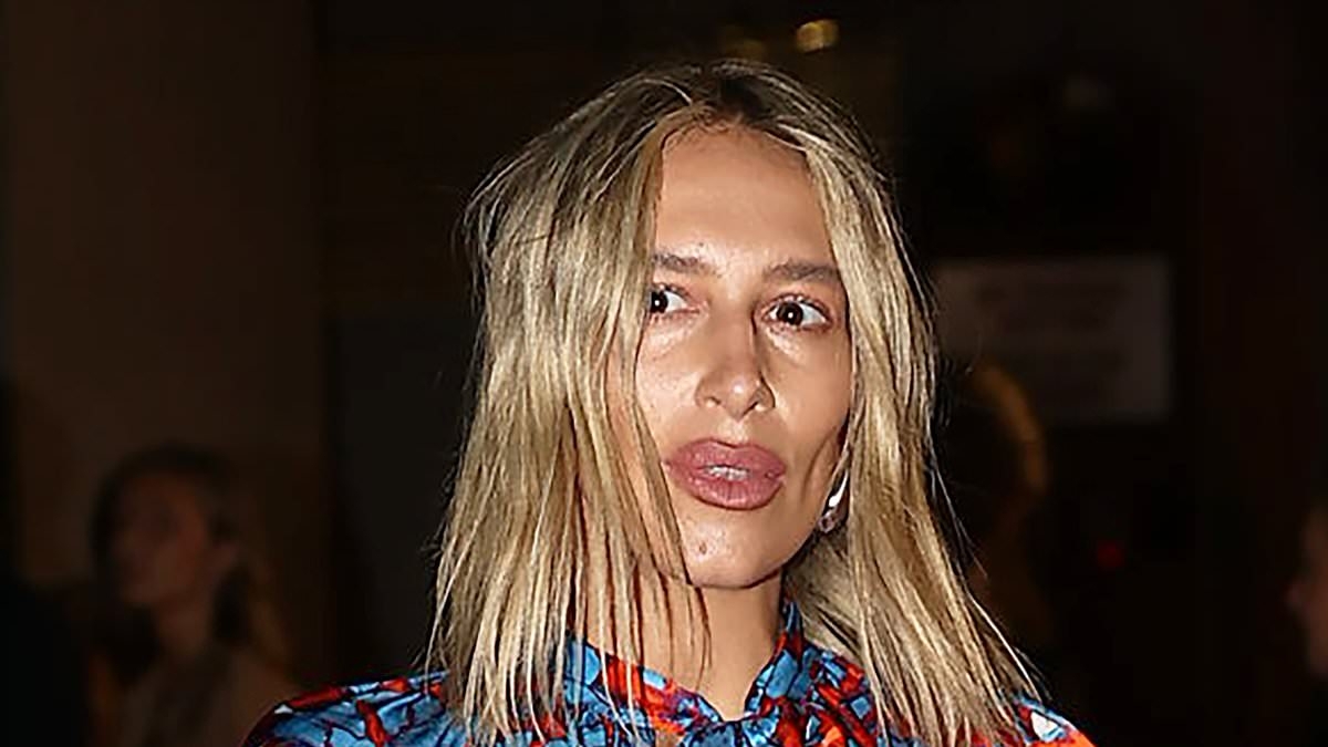 Phoebe Burgess shows off her VERY bold lips as she turns heads in unusual pyjama inspired ensemble at Australian Fashion Week