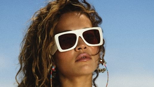 Rita Ora bares her cleavage in skimpy beachwear as she continues to tease her upcoming new single release in a sizzling clip
