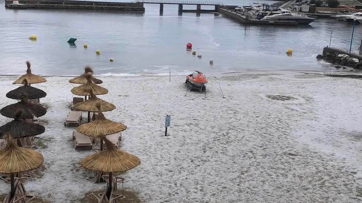Majorca's beaches are turned white with ICE as freak storm hits the tourist hot spot