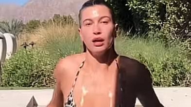 Hailey Bieber is seen dripping wet in a string bikini after telling husband Justin she will 'love you forever'