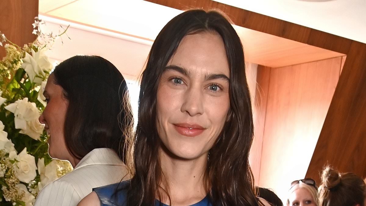 Alexa Chung puts on a racy display in a blue sheer PVC dress as she attends Vogue event in London