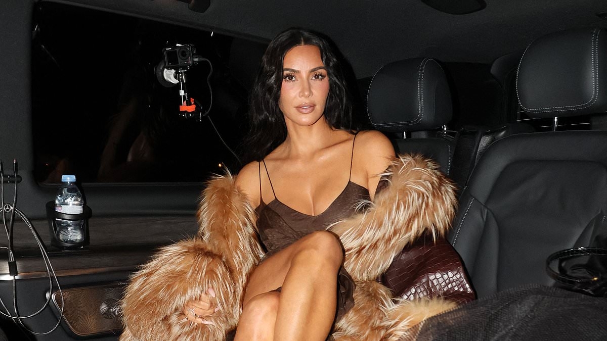 Kim Kardashian puts on a leggy display in brown midi dress as she goes for dinner in Paris hours after emotional court appearance over $10m jewellery heist