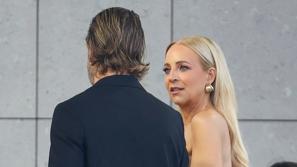 Awkward! Carrie Bickmore's seating faux pas at Australian Fashion Week as she is asked to move at the AJE show by burly front row controller