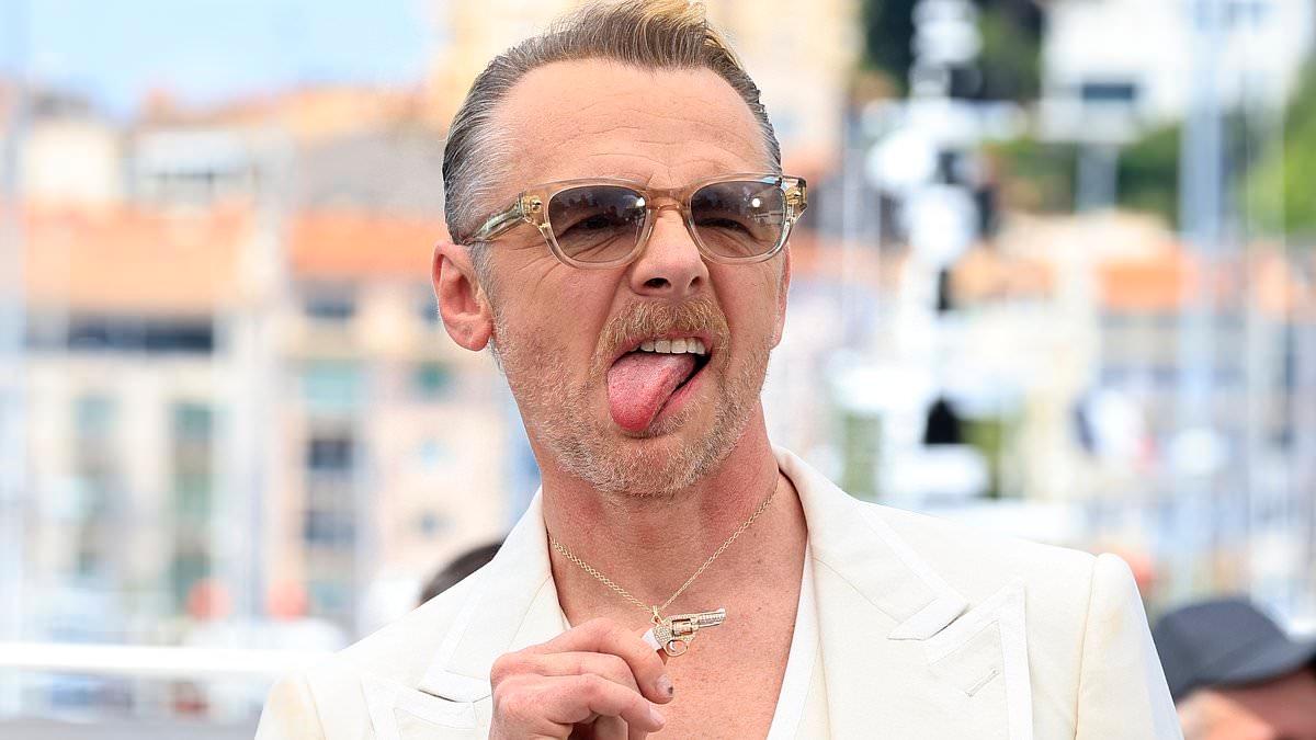 Simon Pegg shows off his edgy new look as he poses with a diamond gun necklace at Mission Impossible photocall during Cannes Film Festival