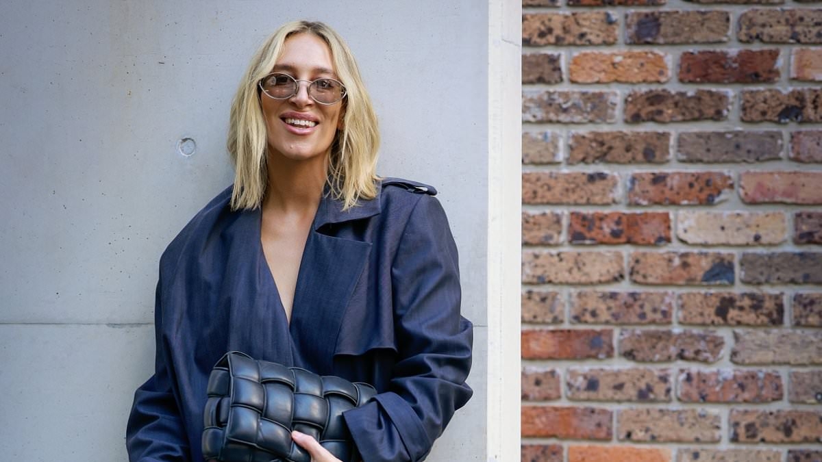 Phoebe Burgess opts for a demure look at Australian Fashion Week after stunning onlookers with bold lips and pyjama inspired ensemble