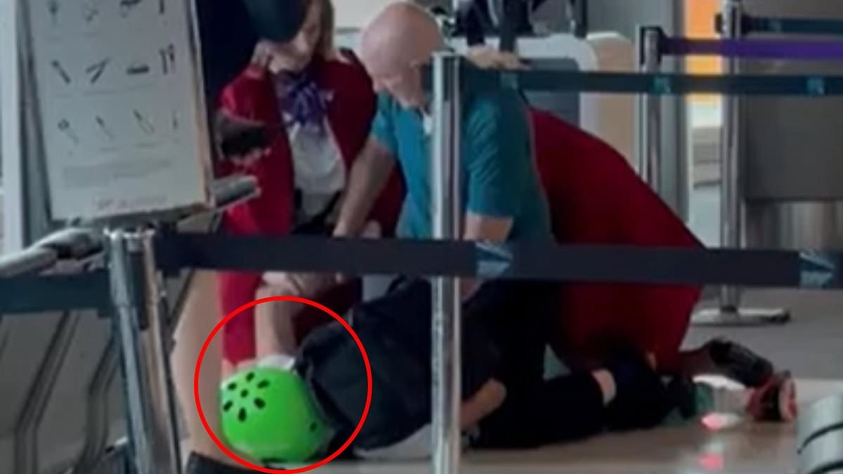 Wild moment man wearing a helmet is tackled to the ground by Virgin cabin crew in front of shocked passengers