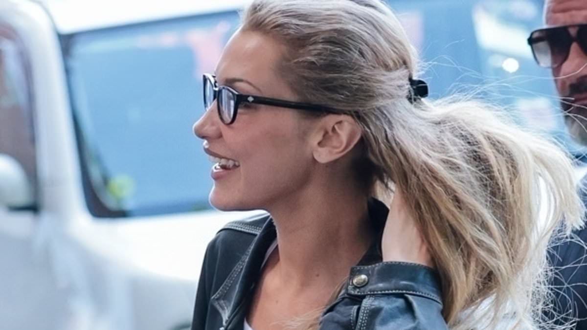 Bella Hadid turns heads in a brown polka dot skirt and denim jacket as she lands in London after debuting her new blonde hairstyle in Cannes