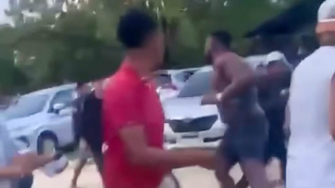 Shocking moment British tourist is attacked by crowd wielding makeshift weapons after getting into a fight with a taxi driver in Bali