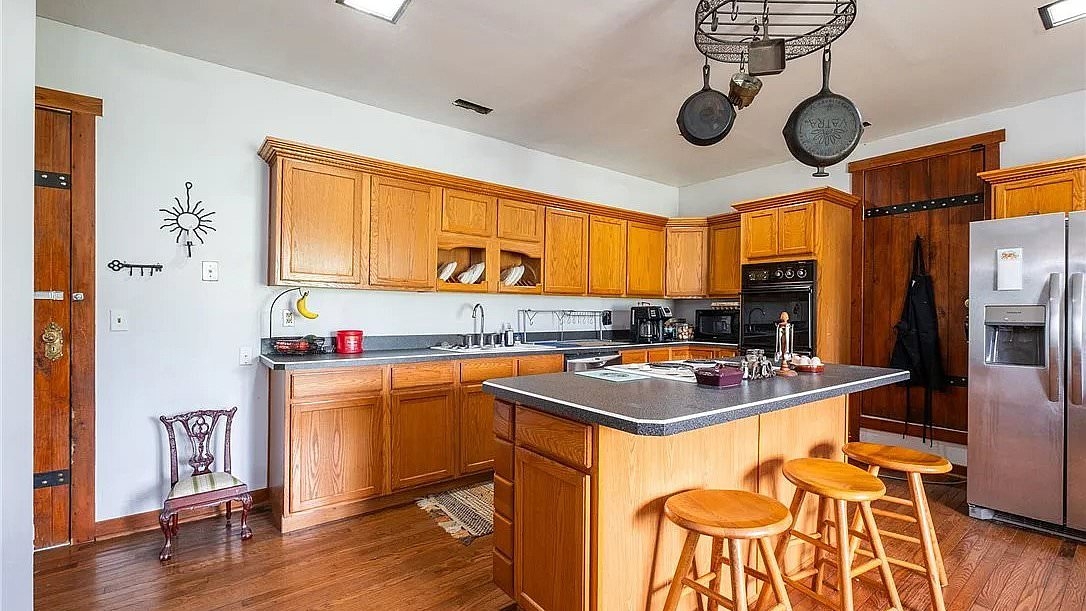 Yellow oak kitchen looks like it should be part of a dated home but its surroundings are INSANE