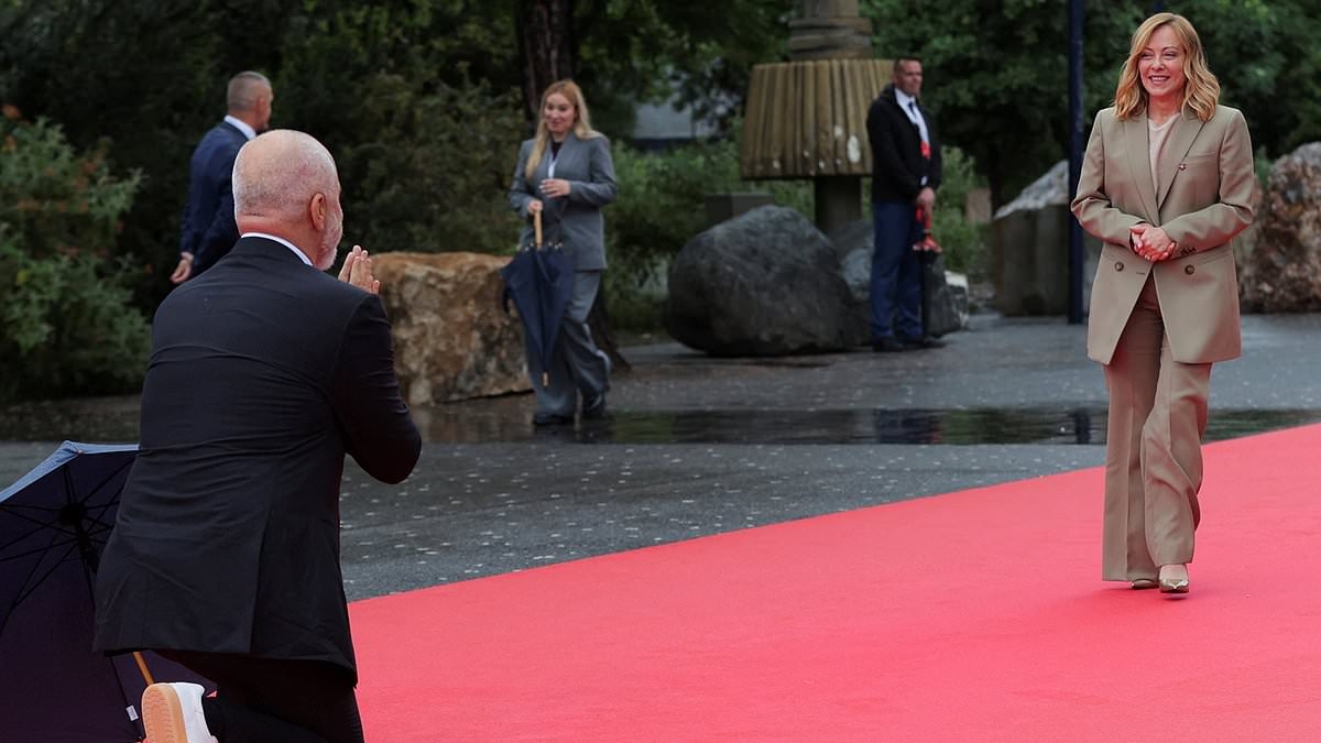 Quite the contrast! Moment Albania's 6ft 7in Prime Minister gushingly takes a knee as he meets Italy's 5ft 3in PM - days after towering over Keir Starmer during their meeting in Tirana