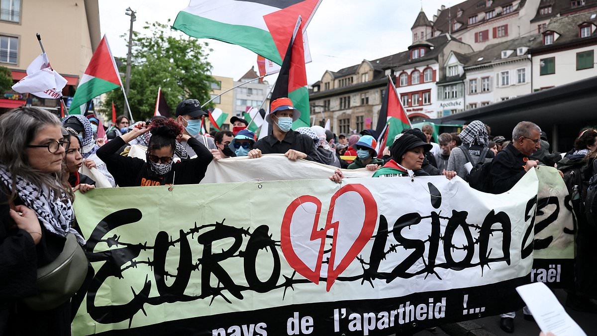 BREAKING NEWS Pro-Palestine demonstrators march on Eurovision: Protestors with 'blood' smeared on their faces rally in Basel amid anger over Israel qualifying for song contest's grand final