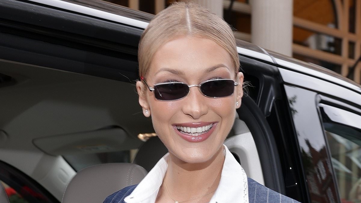 Bella Hadid turns heads in a sophisticated pinstripe dress as she launches her new fragrance Orebella at Selfridges in London