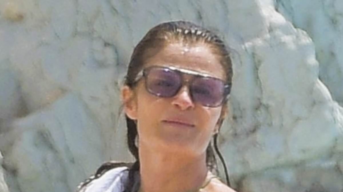 Helena Christensen, 56, shows off her supermodel figure in a pink swimsuit as she enjoys a plunge at the Eden Roc Hotel during Cannes Film Festival