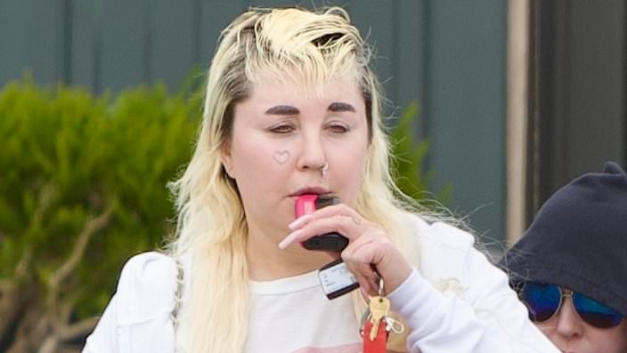 Amanda Bynes, 39, vapes while flashing her tummy in a crop top... after joining OnlyFans