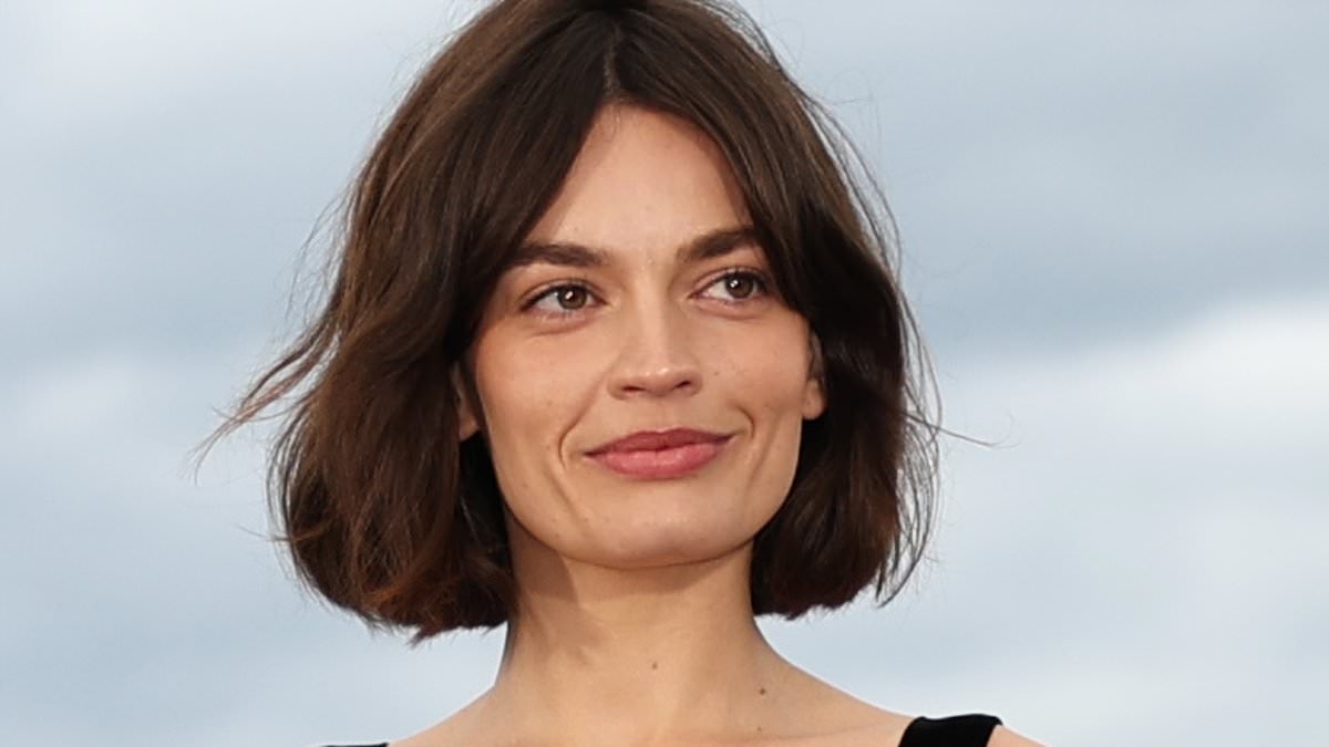 Emma Mackey looks incredible in a figure hugging black dress at the Alpha photocall after debuting new bob hairdo during Cannes Film Festival