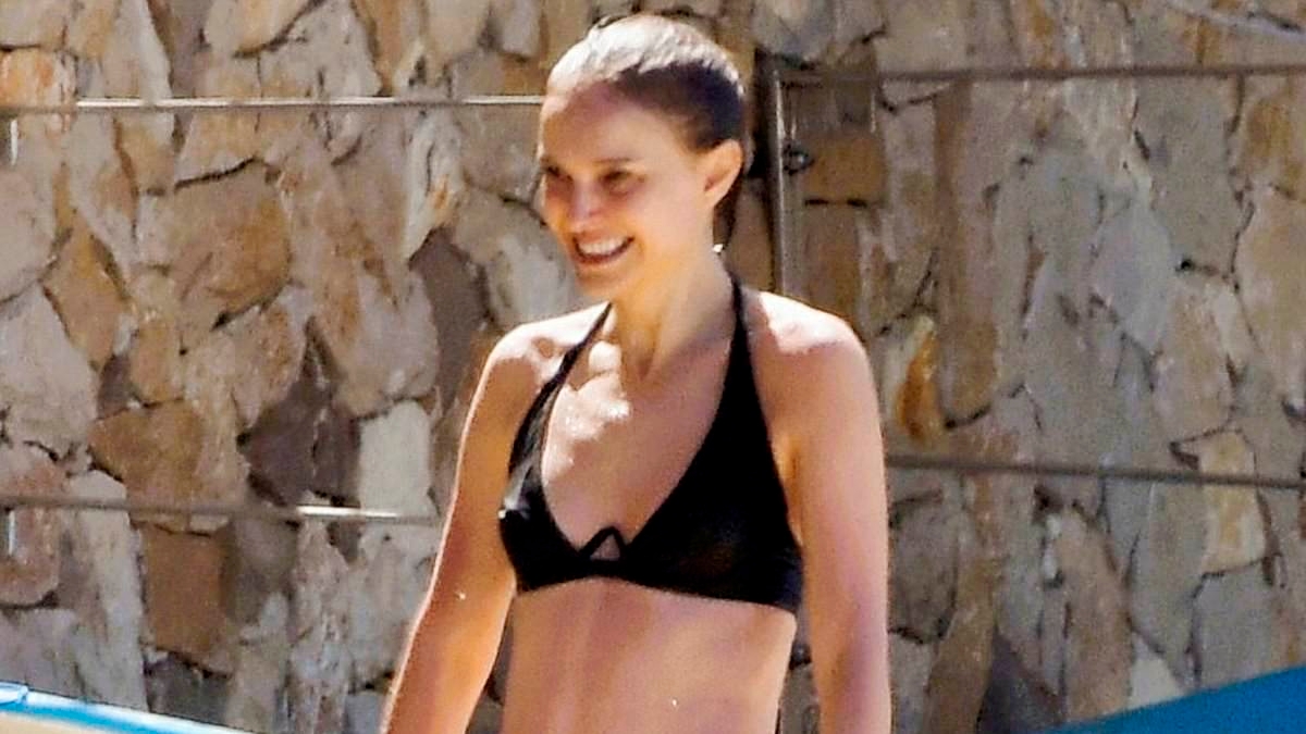 Natalie Portman flashes her abs in a bikini next to a mystery man as she takes a dip in the south of France