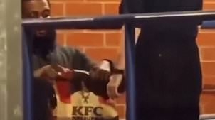 Moment Chris Brown has KFC and clothes delivered to police station where he was remanded in custody charged with attacking nightclub man