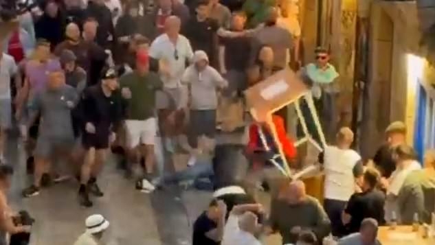 Spanish media hit out at Man United and Tottenham fans for 'destroying the Bilbao streets' ahead of Europa League final - as Brits are spotted tearing down traffic lights and vomiting on the road after night of violence