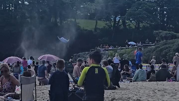 Incredible moment dust-devil sends paddleboard and towels flying high into the air as it hits UK beach