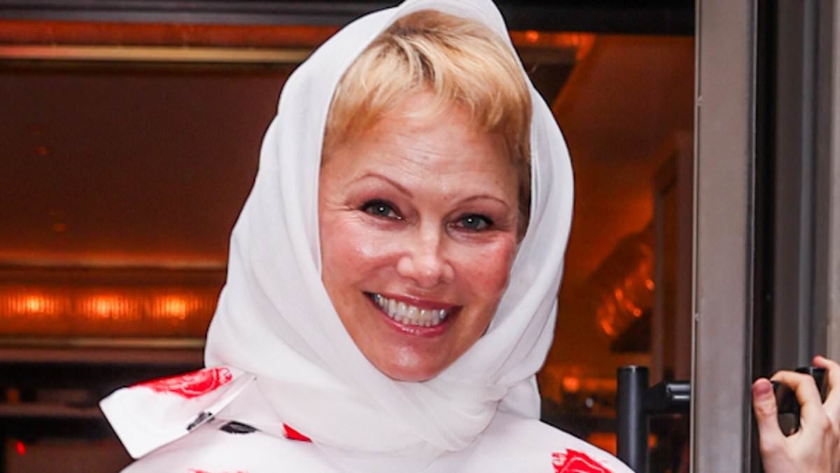 Pamela Anderson wears glam makeup after years of vowing to go bare faced as she steps out in a bold white and red pencil skirt and blouse in New York