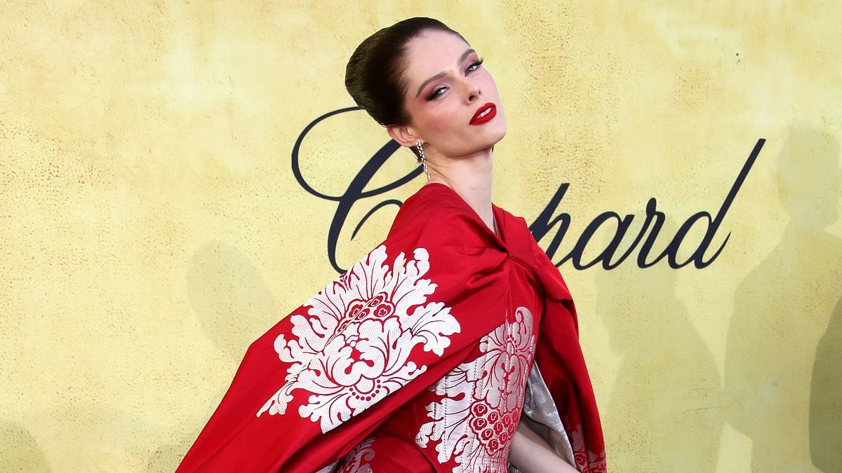 Coco Rocha turns heads in a red oriental-inspired gown as she leads the stars at the amfAR Gala during the 78th Cannes Film Festival