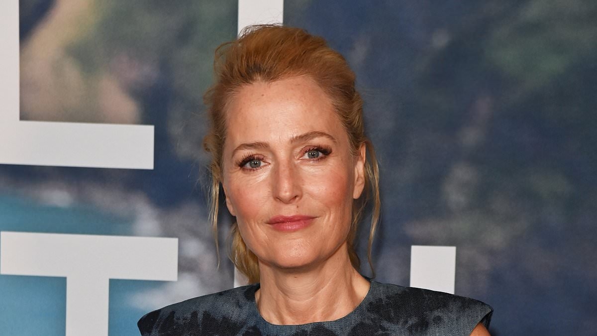 Gillian Anderson stuns in an elegant blue midi dress as she joins dapper co-star Jason Isaacs at the UK screening of The Salt Path