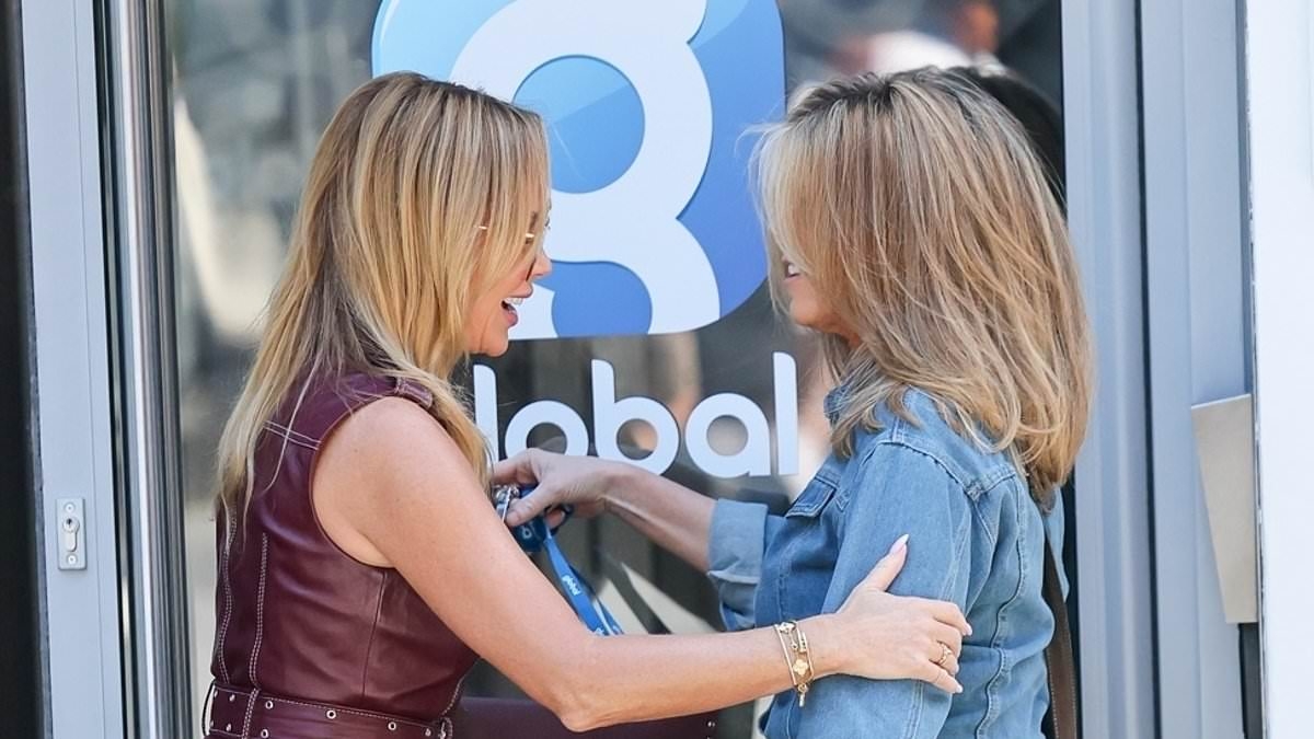Kate Garraway looks delighted as she bumps into Amanda Holden outside their radio station office in London