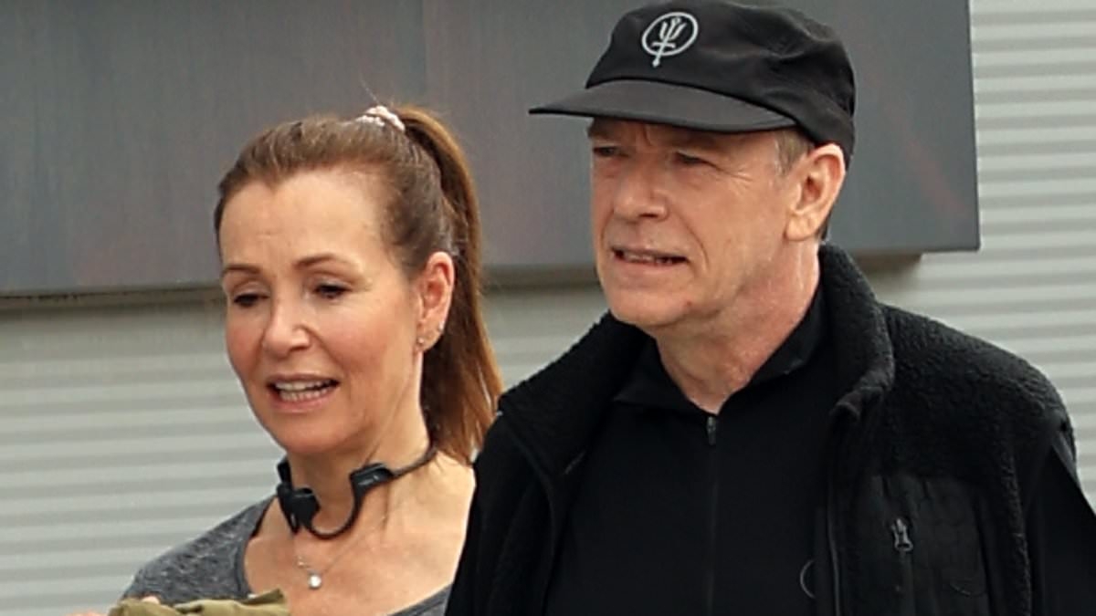 EastEnders star Adam Woodyatt looks loved-up with mystery woman as they leave the gym together in London - three years after divorce from wife Beverley Sharp