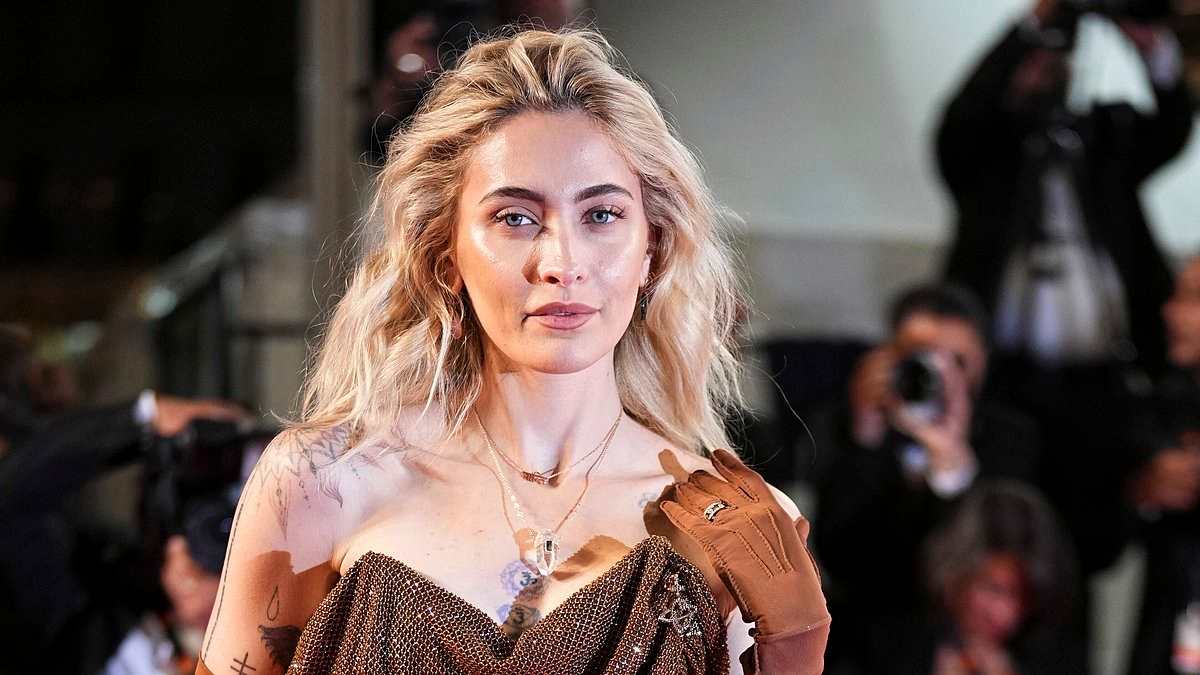 Paris Jackson puts on a VERY leggy display in a brown thigh-split gown as she joins glamorous Margaret Qualley at the Honey Don't! premiere during Cannes Film Festival