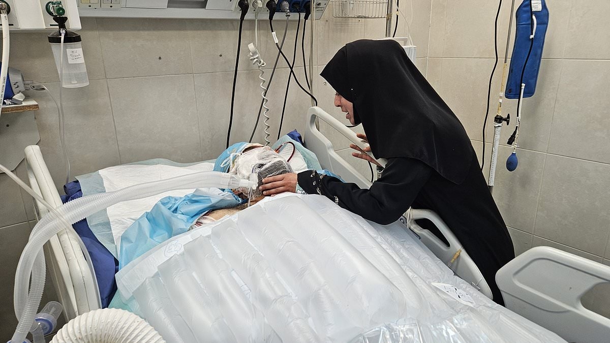 Doctor still fighting for his life after Israeli strike killed nine of his 10 children - as heartbreaking snap shows wife at his bedside
