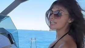 Samie Elishi shows off her jaw-dropping figure in a black bikini as she enjoys a boozy boat day during a sun-soaked holiday after that steamy Sam Thompson kiss