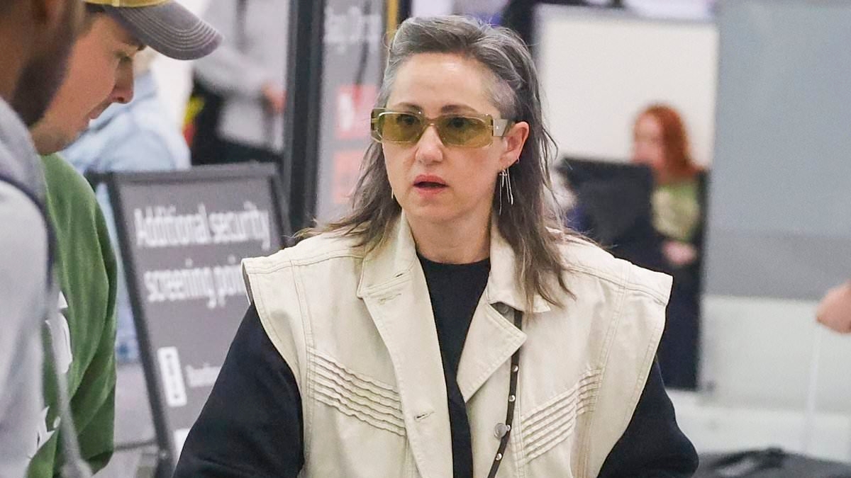 Guess who! Noughties pop star who gained massive success for her Devil Wears Prada anthem looks unrecognisable at Sydney Airport