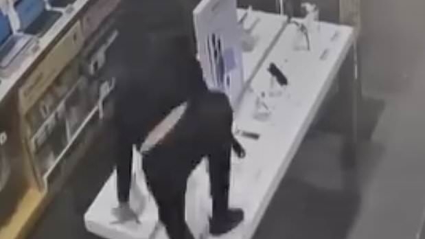 Moment 'Britain's dumbest crooks' try to steal phones from Currys by KICKING them off their displays