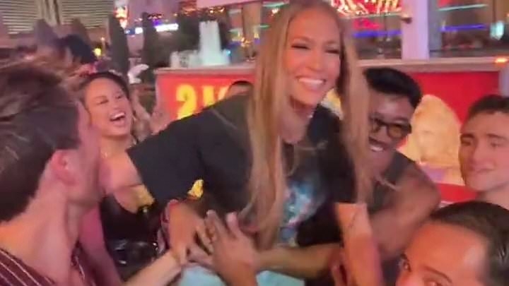 Jennifer Lopez enjoys a wild night out in Las Vegas as she parties on an open-top bus - after THAT cringe-worthy lesbian kiss at the AMAs