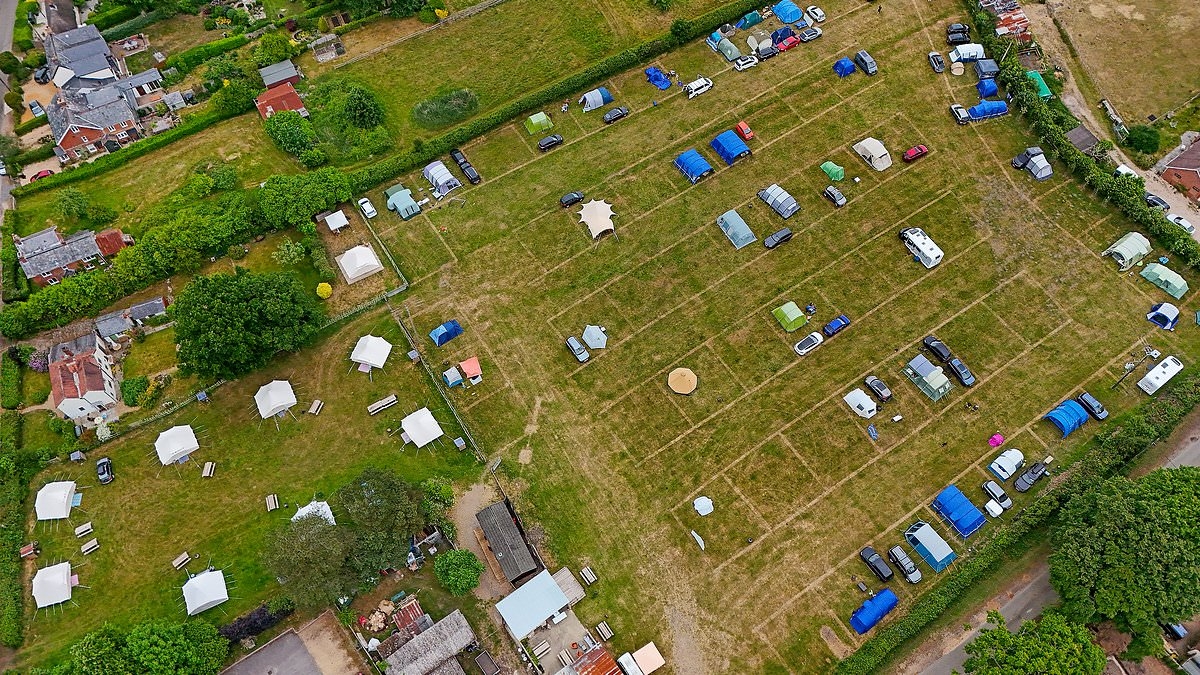 Smoked out! Villagers living next to a posh campsite claim they are being forced to sell their homes over 'excessive smoke' from trendy fire pits