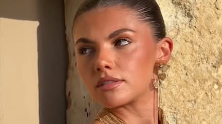 Braless Samie Elishi sets pulses racing in a plunging gold crochet dress as she soaks up the sun on holiday after that steamy kiss with Sam Thompson