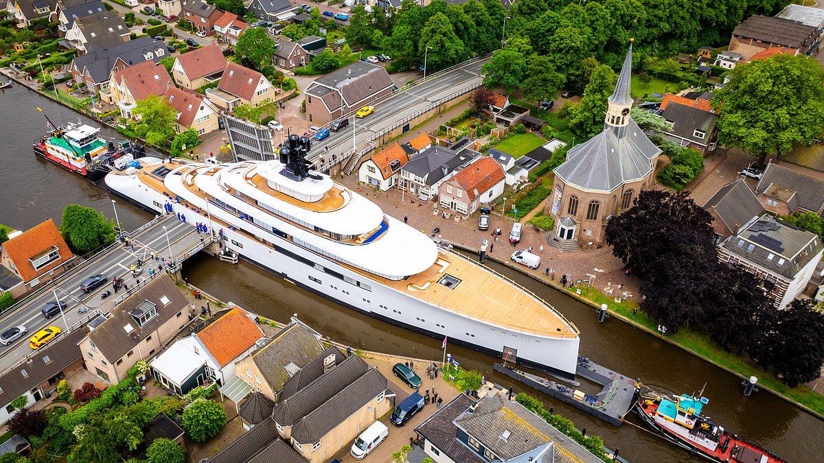 Not a latte room for error! £150million superyacht owned by ex-Starbucks CEO squeezes through Dutch canal with inches to spare