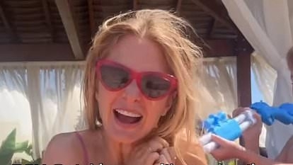 Millie Mackintosh flaunts her toned figure in bold bikini as she's drenched with water by her children in playful video after revealing she secretly struggled with her sexuality during alcohol battle