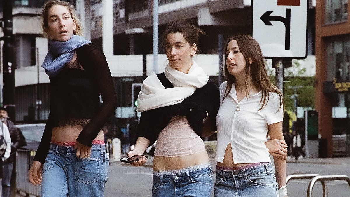 HAIM pose for their new album cover in a VERY unlikely location while sporting a WHSmith carrier bag - and fans are going wild