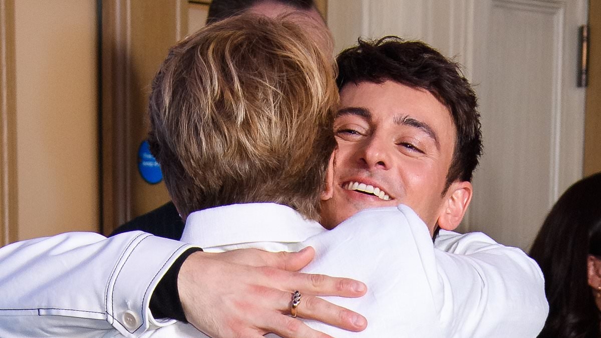 Tom Daley is supported by Celebrity Traitors co-star Clare Balding as they share a hug at his 1.6 Seconds documentary screening in London